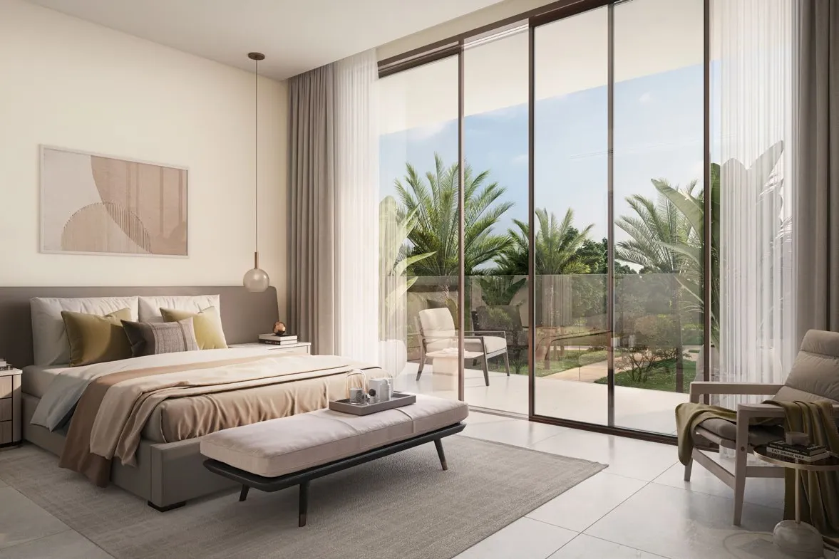 Bedroom with glass doors opening onto a balcony and palms