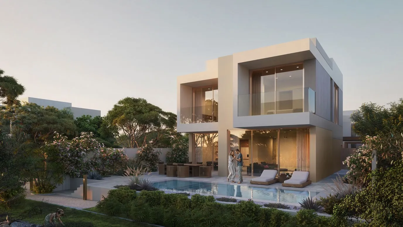 Two-storey villa at dusk with private pool and lush garden